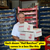 Man holding shipping boxes for dozens of Hubig's pies.