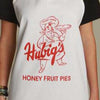 Person wearing a white apron with Hubig's Honey Fruit Pies logo