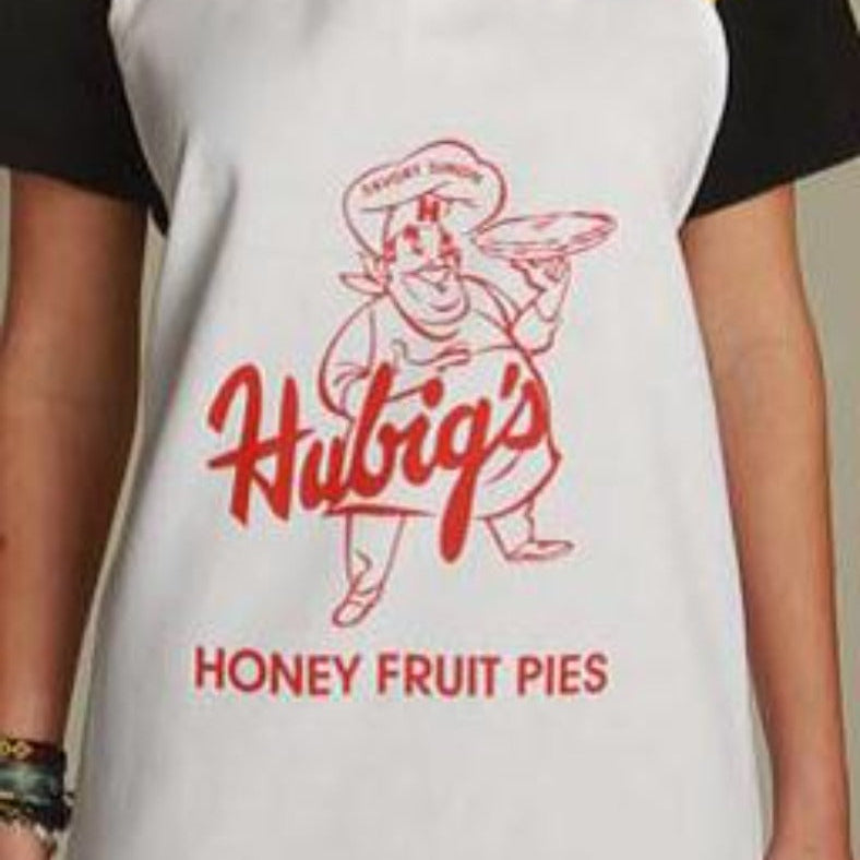 Person wearing a white apron with Hubig's Honey Fruit Pies logo